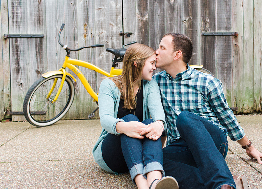 couple kissing in front of bike