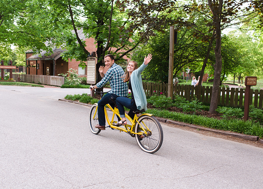 couple waving from tandem bike